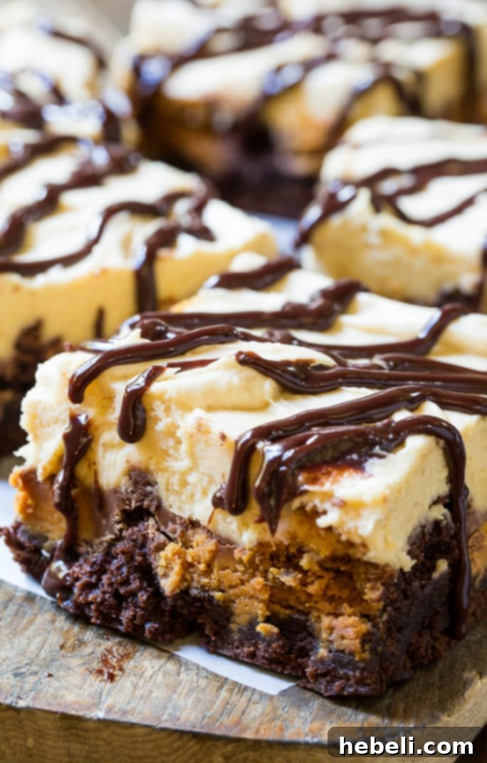 Frosted Peanut Butter Cup Brownies with chocolate drizzle, neatly cut into perfect squares for serving