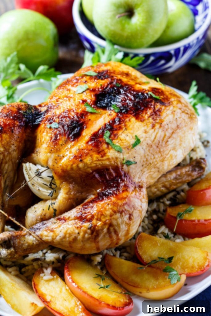Plated Apple Cider Glazed Roasted Chicken, served with a side of rice pilaf and green beans, showcasing a complete and appetizing meal