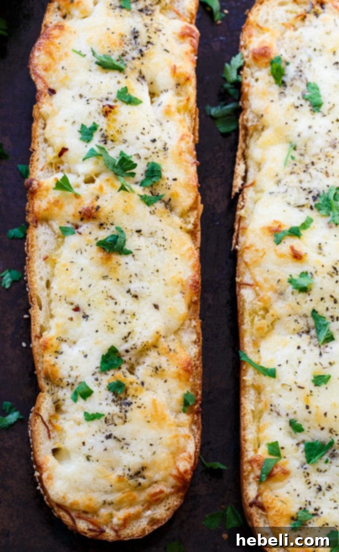 Ooey Gooey Garlic Bread 4 Close-up of a slice of cheesy garlic bread with melted cheese and fresh parsley.