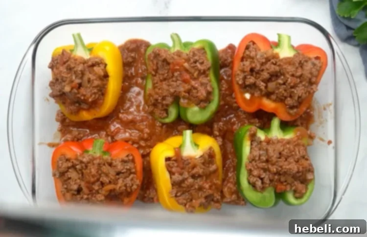 Lasagna Bell Pepper Bake 7 Layering ground beef mixture into the stuffed bell peppers.