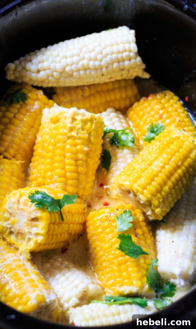 Easy Crock Pot Corn on the Cob 2 Crock Pot Corn on the Cob cooked with coconut milk and butter, served on a platter.