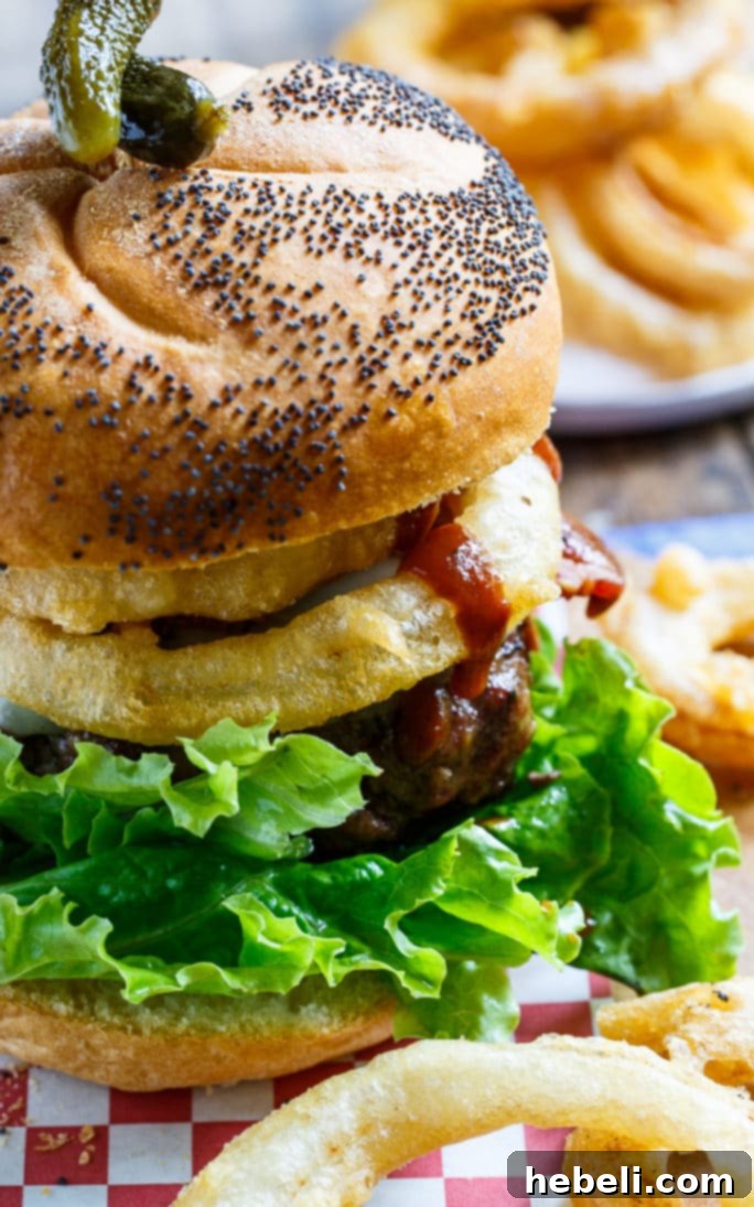 Appetizing shot of multiple Cowboy Burgers, ready to be served, garnished with fresh lettuce.