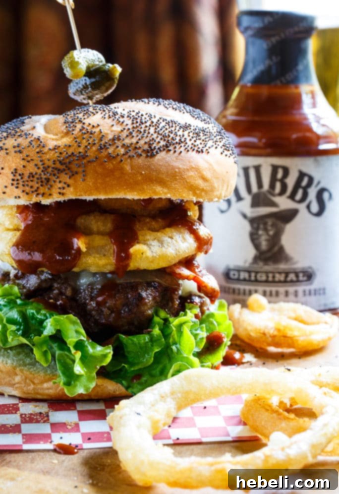 A spread of Cowboy Burgers, featuring bacon, BBQ sauce, and homemade onion rings, ready for a feast.