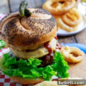 Cowboy Burgers topped with bacon, onion rings, and bbq sauce.