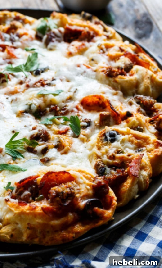 Plate of cheesy Pull-Apart Supreme Pizza Pinwheels from Melissa's Southern Cookbook.