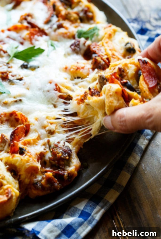Freshly baked Pull-Apart Supreme Pizza Pinwheels, showcasing their golden crust and cheesy filling.
