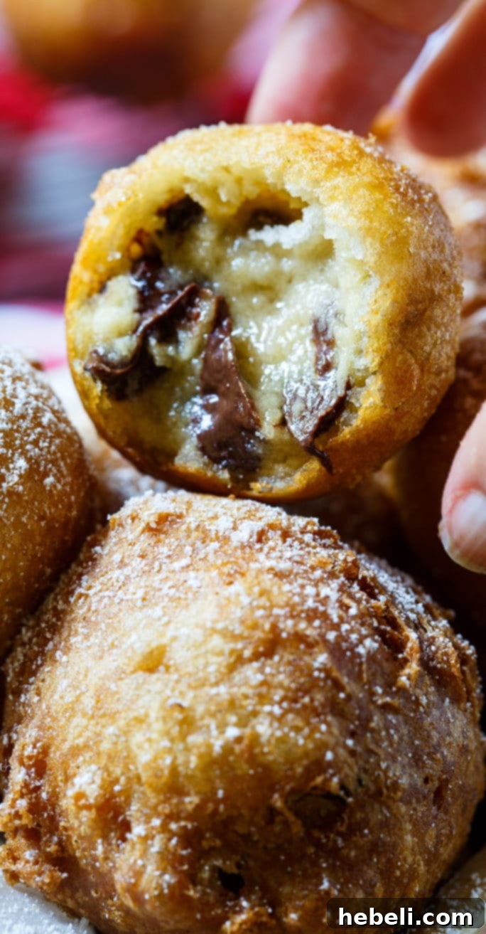 Deep-Fried Cookie Dough balls being carefully fried to a perfect golden crisp in bubbling hot oil