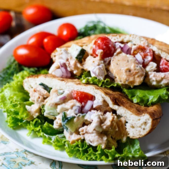 Greek Salmon Pita Sandwich - A fresh, vibrant pita sandwich filled with salmon, cucumber, tomatoes, and feta