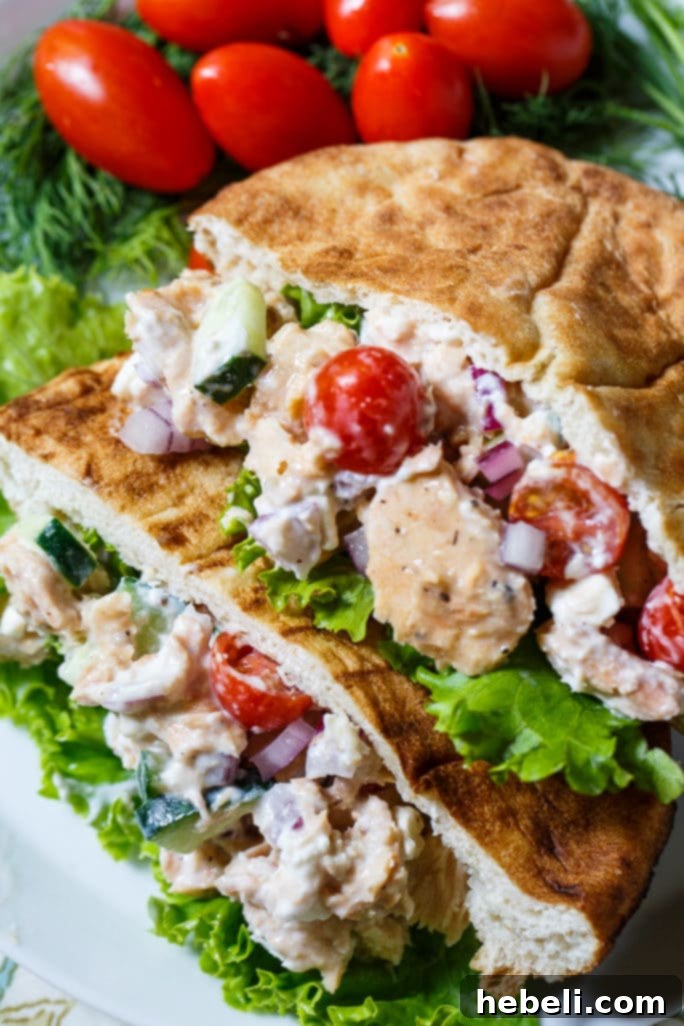 Prepared Greek Salmon Pita Sandwiches on a wooden board