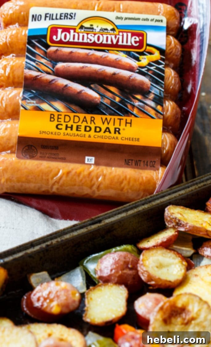 Oven-Roasted Sausage and Potatoes arranged neatly on a baking sheet before going into the oven.