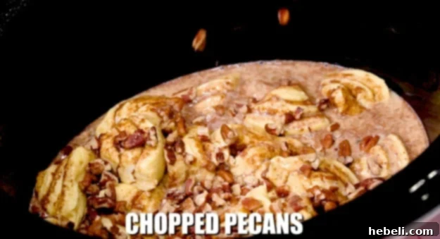 Chopped pecans sprinkled generously over the unbaked cinnamon roll casserole.