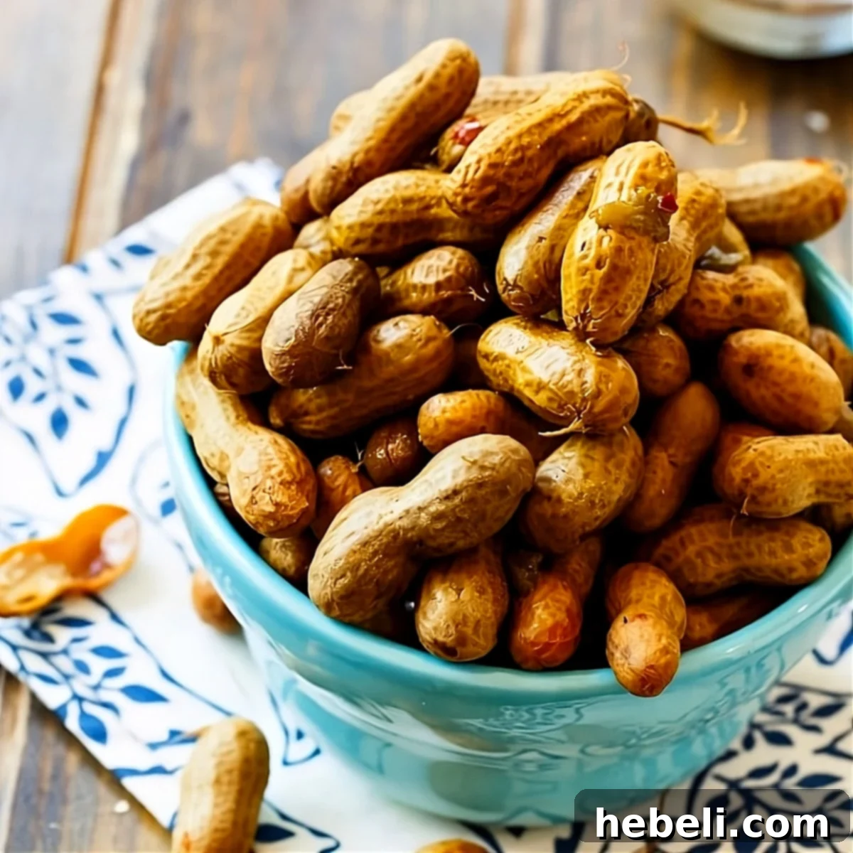 Fiery Crock Pot Boiled Peanuts 2 A vibrant blue bowl filled with spicy boiled peanuts, ready to be enjoyed as a classic Southern snack.
