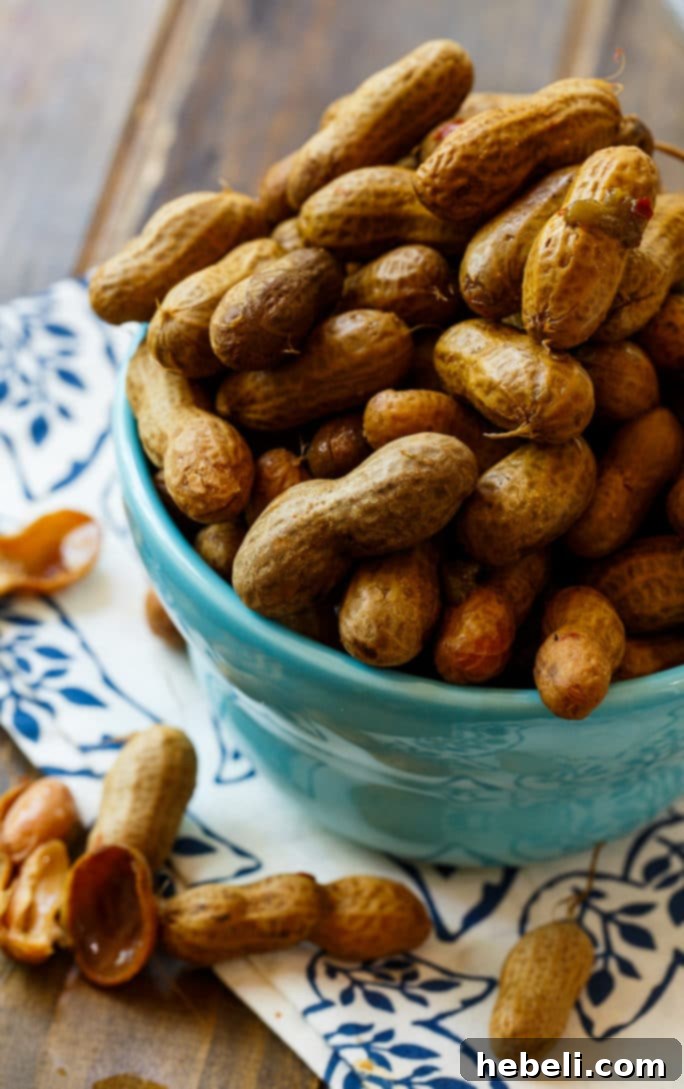 Fiery Crock Pot Boiled Peanuts 4 A large batch of spicy boiled peanuts simmering gently in a crock pot, releasing their aromatic flavors.
