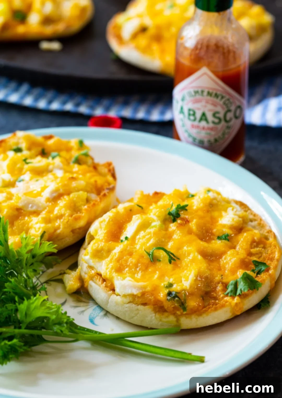 Sensational Crab Melts 6 Two perfectly golden brown Crab Melts arranged on a pristine white plate, showcasing the rich crab topping and beautifully melted cheese, ready to be enjoyed.