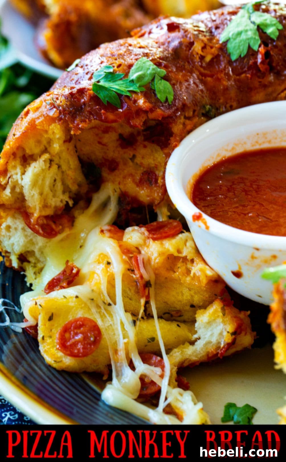 A serving of Pizza Monkey Bread with a bowl of marinara sauce on the side.