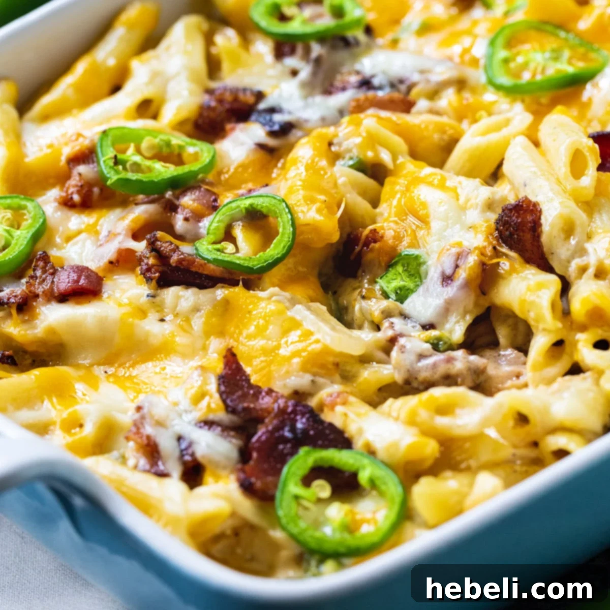 Kickin' Jalapeno Popper Chicken Bake 2 A golden-brown Jalapeno Popper Chicken Casserole in a baking dish, fresh from the oven, with bubbling cheese and crispy toppings.