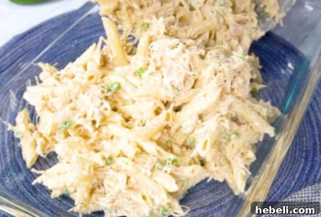 Kickin' Jalapeno Popper Chicken Bake 9 The assembled casserole mixture being transferred into a baking dish before baking.