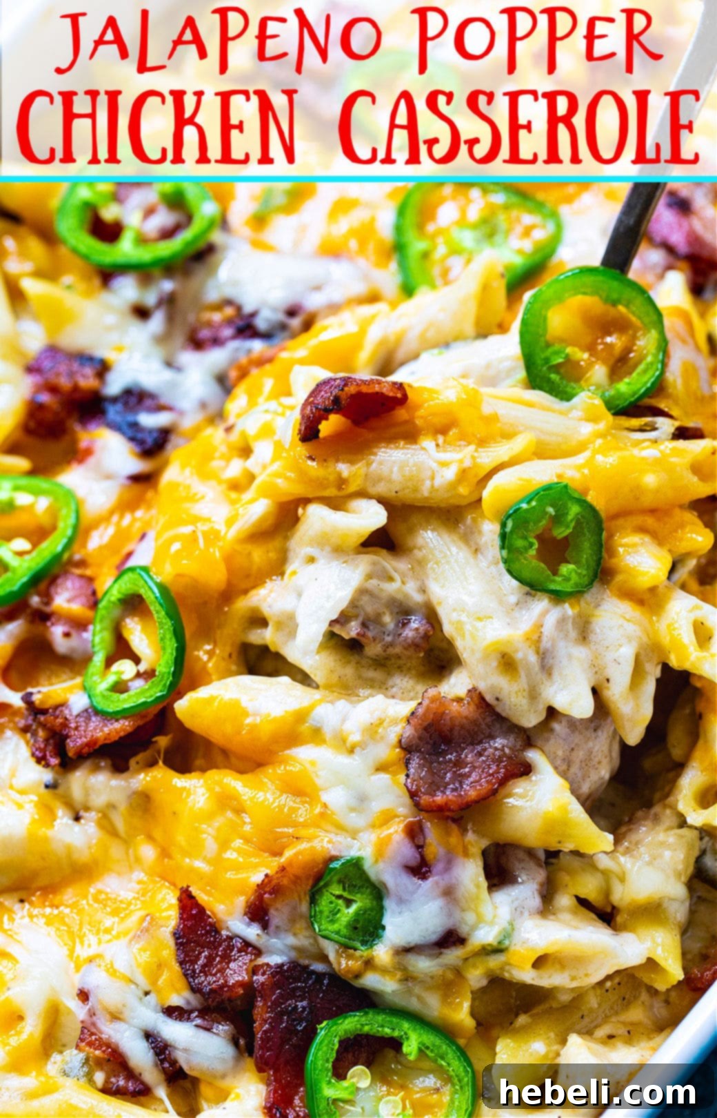 Kickin' Jalapeno Popper Chicken Bake 11 A serving spoon lifting a portion of the creamy Jalapeno Popper Chicken Casserole, showcasing its delicious layers and toppings.
