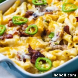 Jalapeno Popper Chicken Casserole ready to be served, topped with fresh jalapenos.