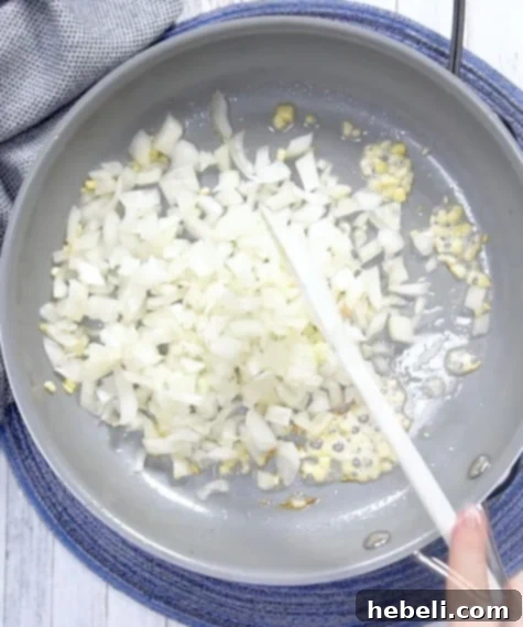 Kickin' Jalapeno Popper Chicken Bake 3 Cooking the onion and garlic in bacon grease, releasing aromatic flavors.
