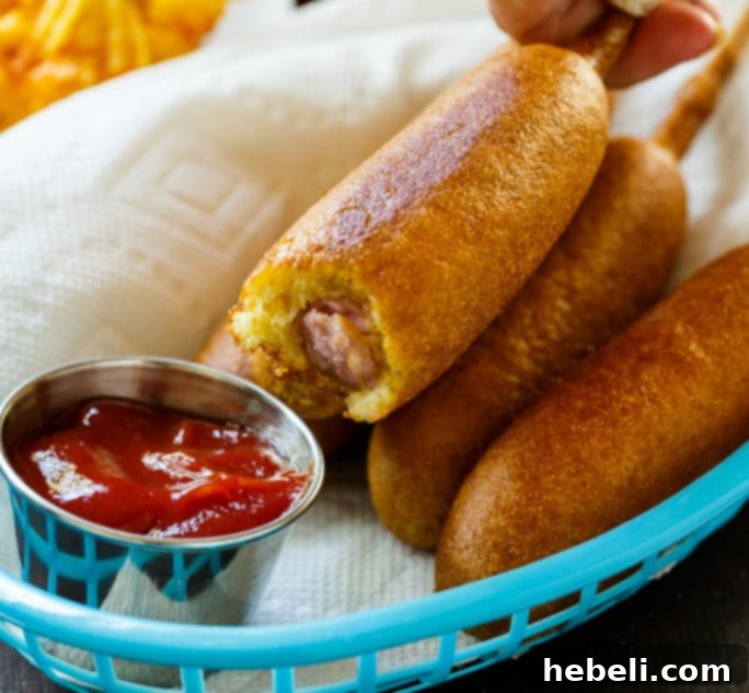 A close-up of a Johnsonville Corn Dog showing its crispy batter and juicy sausage