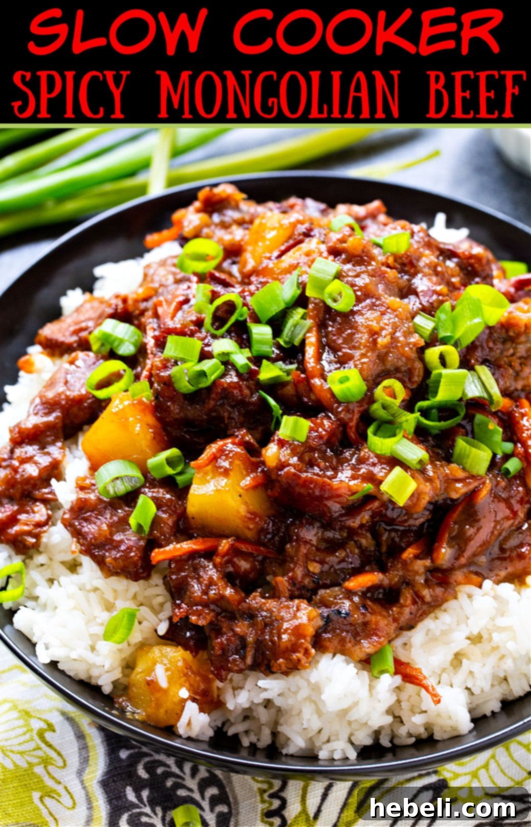A beautifully presented bowl of Slow Cooker Spicy Mongolian Beef with Pineapple, garnished and ready to be enjoyed.