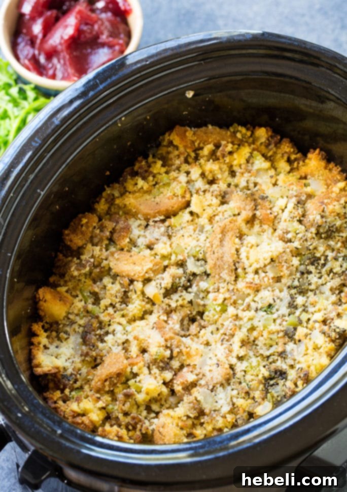 Close-up of Slow Cooker Sausage Cornbread Dressing showing texture and ingredients.