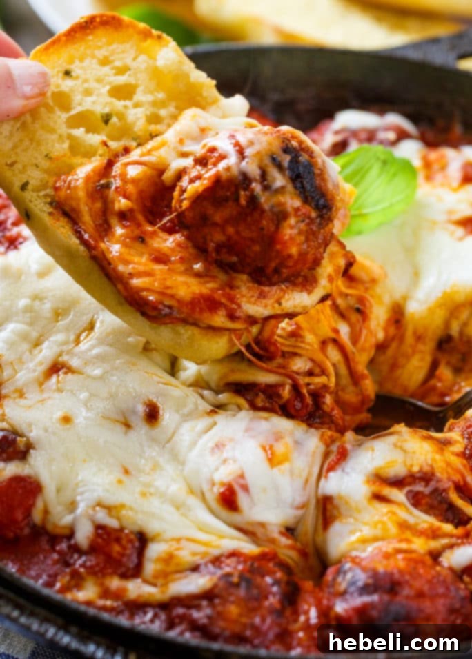 Cheesy Meatball Skillet served with slices of garlic bread for a fun and easy appetizer.