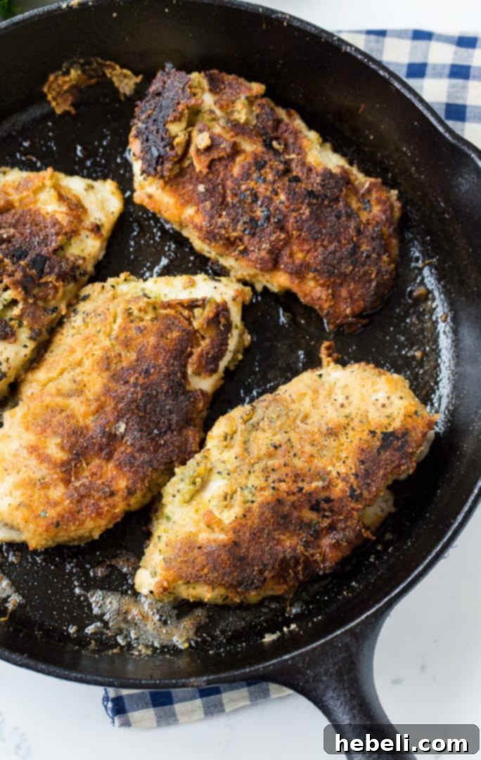 Close-up of crispy Pesto Pan-Fried Chicken showing the breadcrumb coating.