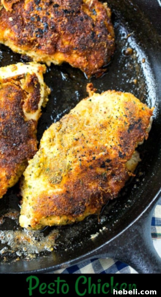 Pan-fried chicken cooking in a cast iron skillet, showing the crispy texture.