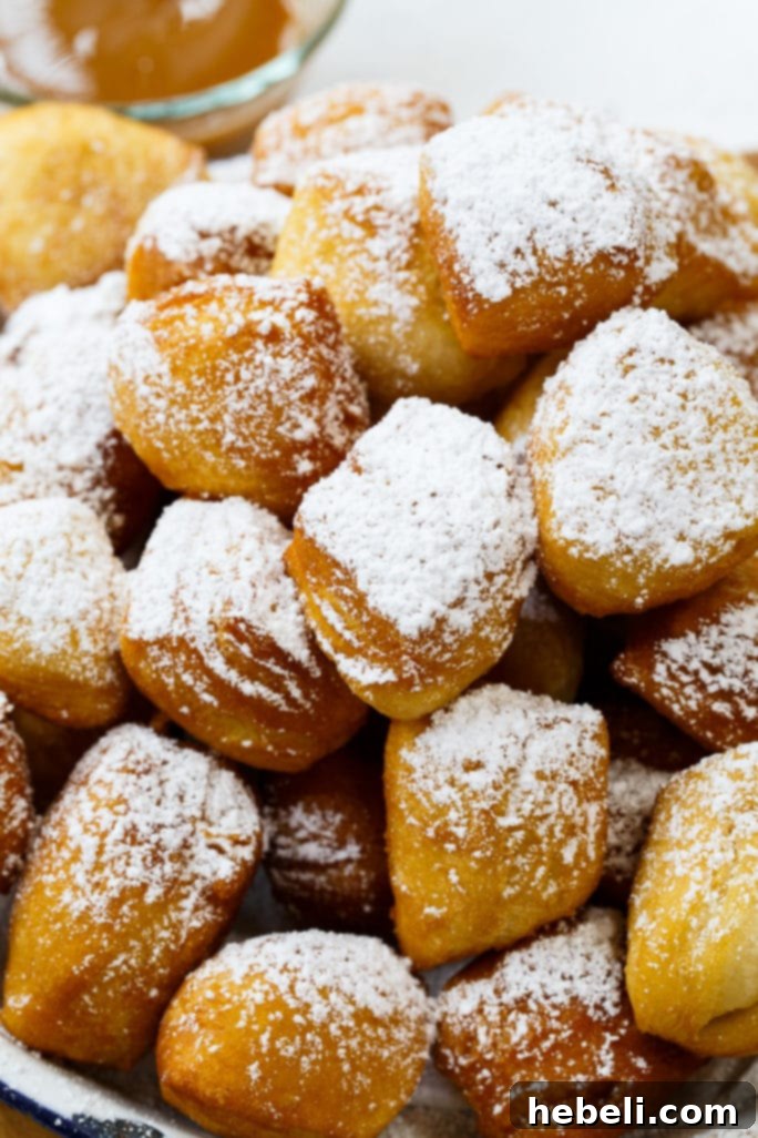 Golden Biscuit Fritters 4 A plate of freshly fried Biscuit Beignets awaiting a generous sprinkle of powdered sugar