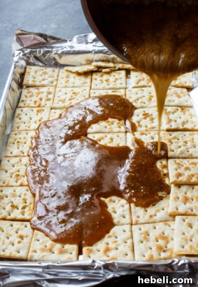 Sweet and Salty Cracker Delight 4 Preparation steps for Saltine Cracker Candy, showing melted chocolate spread over crackers.