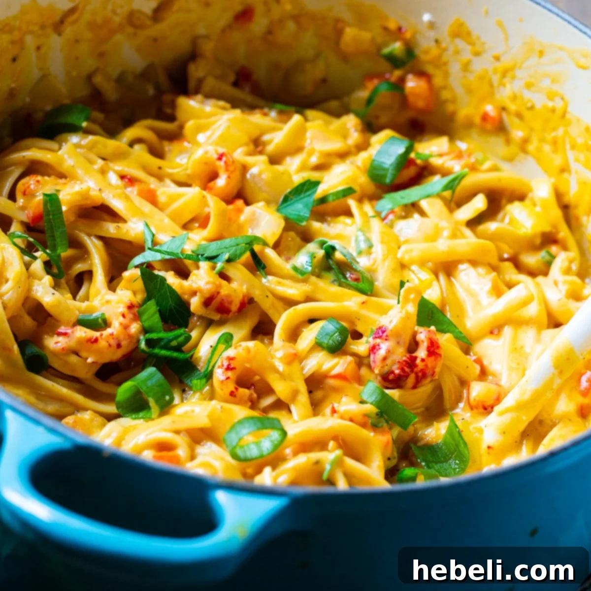 A Dutch oven filled with creamy crawfish fettuccine, ready to be served.