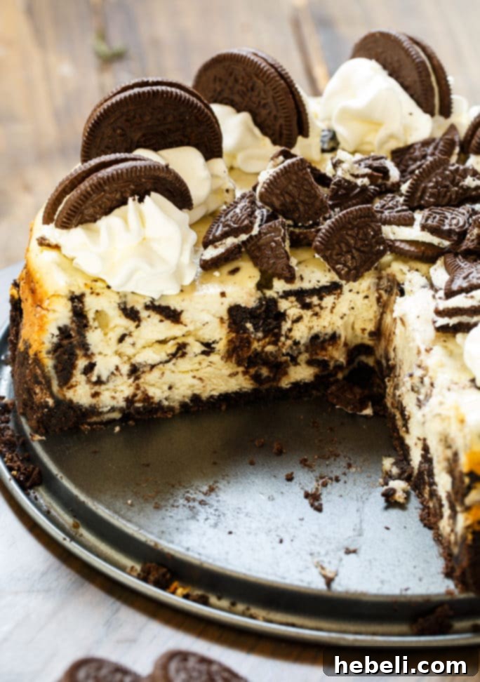 Oreo Cheesecake is super creamy with lots of oreo cookie pieces, topped with fresh whipped cream.