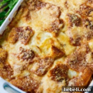 Scalloped Potato Casserole with a layer of crispy bread slices and melted cheese on top.