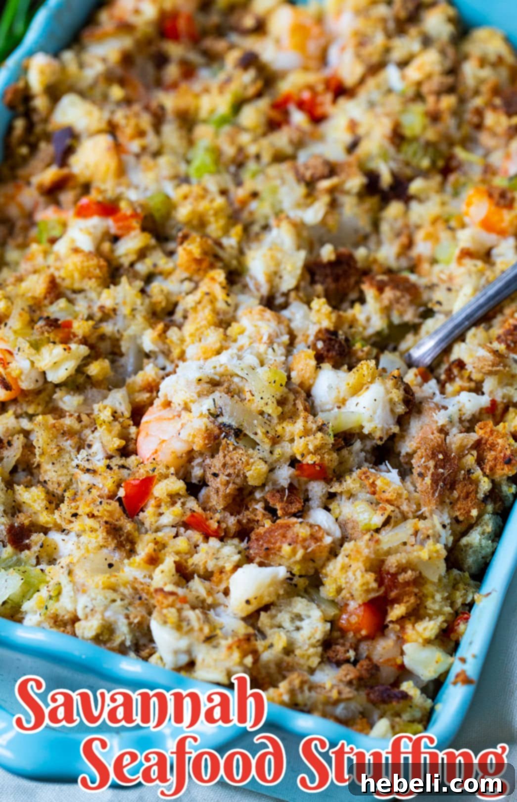 A close-up serving of Savannah Seafood Stuffing in a blue dish, garnished with fresh parsley, highlighting its savory and inviting texture.