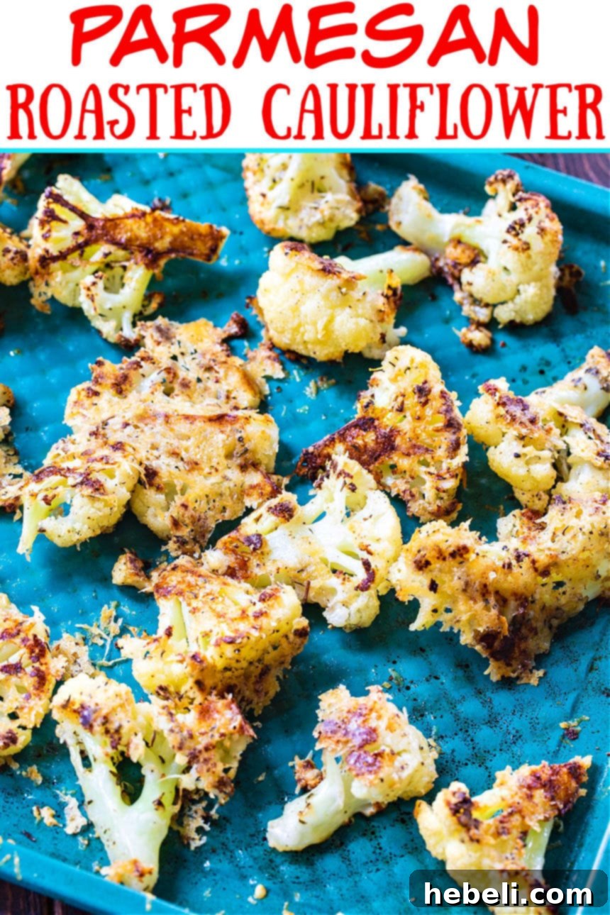 Parmesan Roasted Cauliflower florets spread evenly on a baking sheet, ready for the oven.