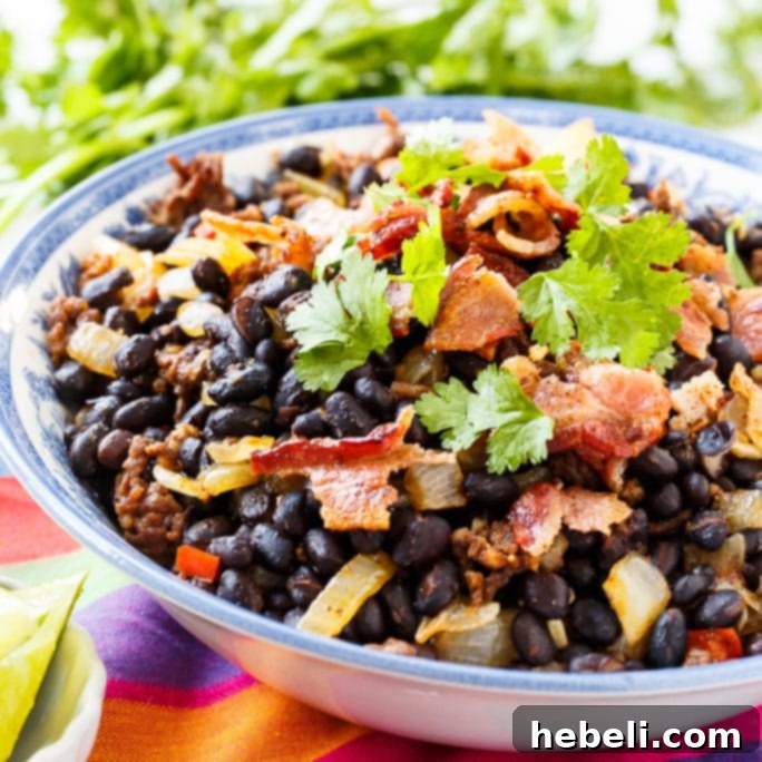 A vibrant bowl of Chorizo Black Beans, garnished with fresh cilantro, ready to be served as a delicious Mexican side.