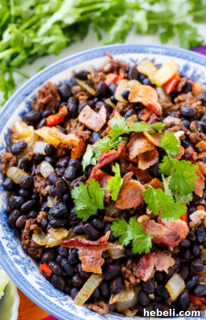 Overhead shot of freshly cooked Chorizo Black Beans in a rustic bowl, highlighting their rich, appetizing appearance.