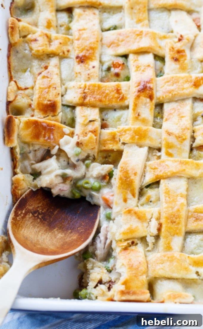 Close-up of the intricate lattice top on a golden-baked chicken pot pie, showing perfect flakiness.