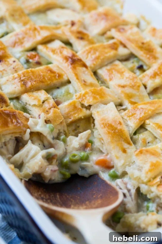 A hearty slice of Chicken Pot Pie showing the creamy filling, tender chicken, and colorful vegetables.