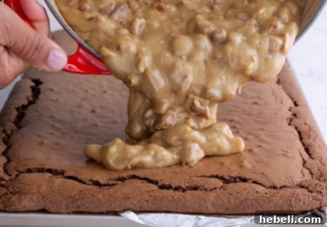 Pouring frosting on cake.