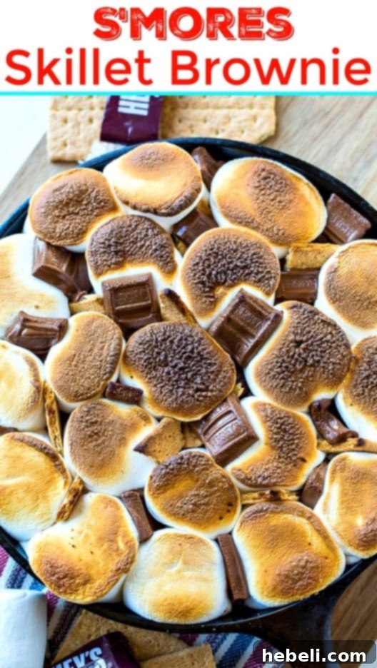 S'mores Brownie in cast iron skillet with perfectly toasted marshmallows and melted chocolate pieces