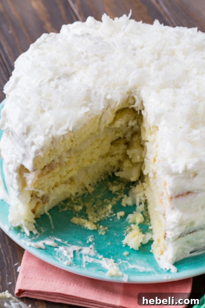Close-up view of the irresistible Coconut Celebration Cake, highlighting its soft texture.