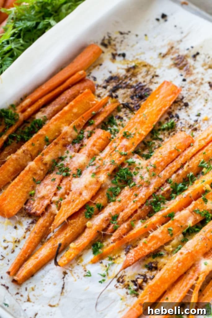 Peeled carrots neatly cut in half lengthwise, ready for seasoning and roasting