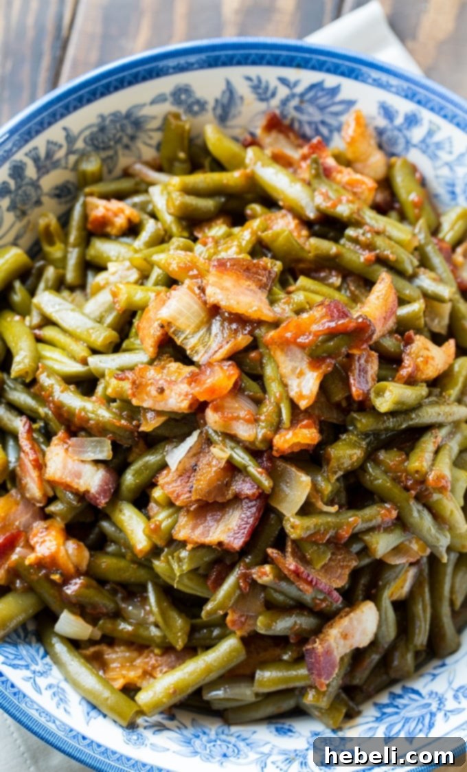 A serving bowl filled with Slow Cooker Barbecued Green Beans, perfectly cooked and glistening.