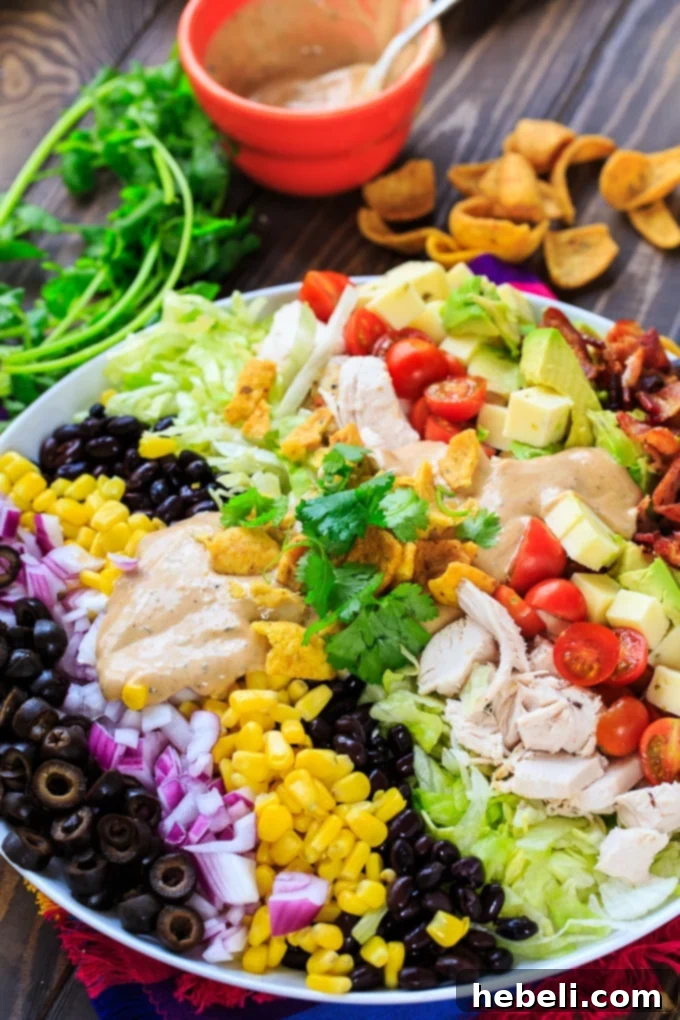 A generously sized Tex-Mex Cobb Salad, showcasing all its fresh ingredients and BBQ Ranch Dressing