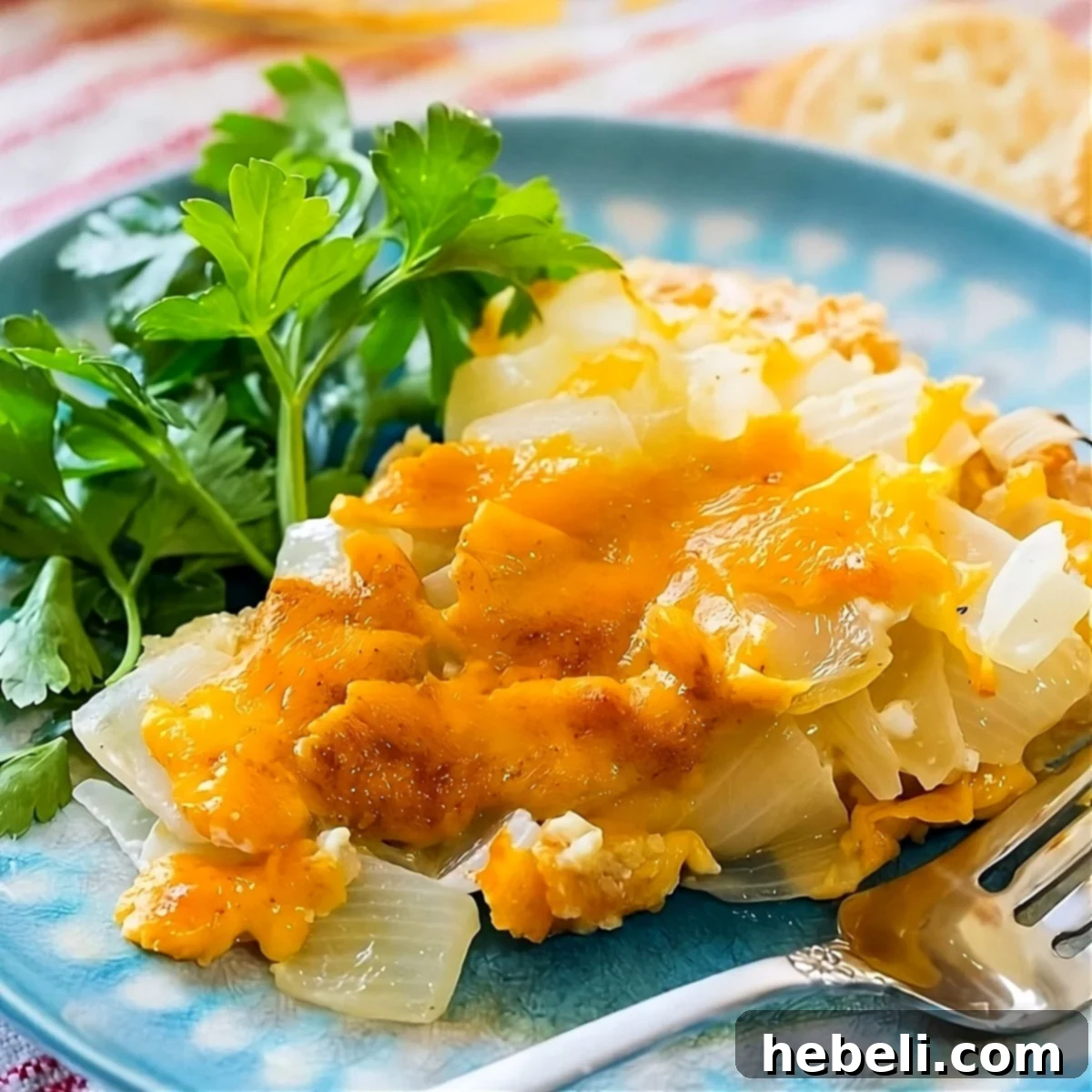 A delectable slice of Vidalia Onion Pie with Ritz Cracker Crust elegantly placed on a plate, showcasing its golden-brown top and creamy filling.