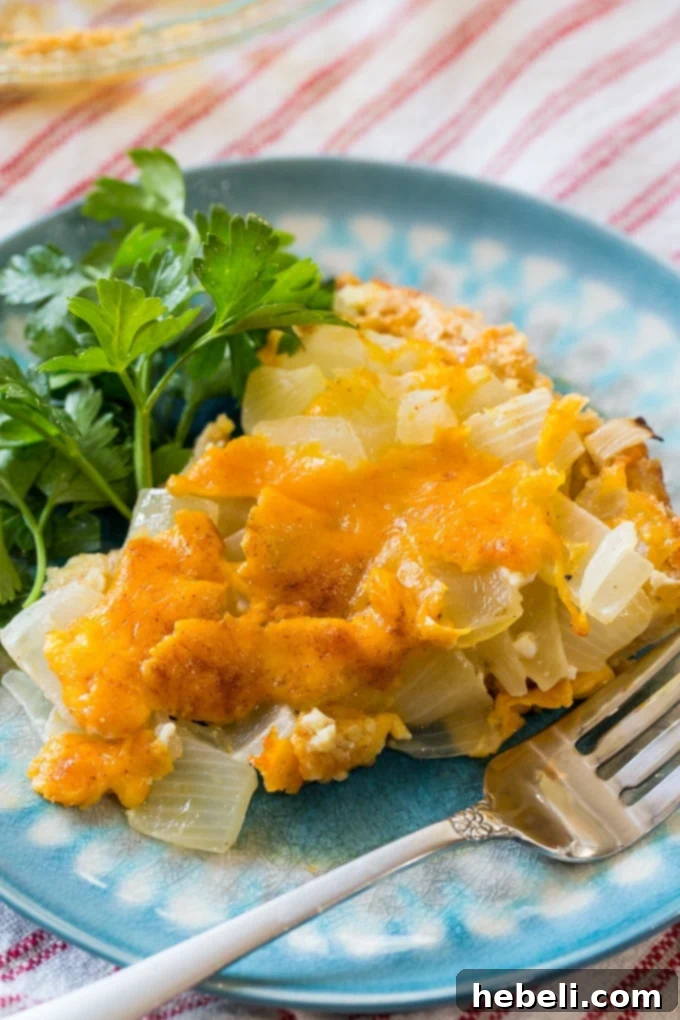 A close-up shot of Vidalia Onion Pie with Ritz Cracker Crust and a generous sprinkle of melted cheddar cheese, highlighting its savory appeal.