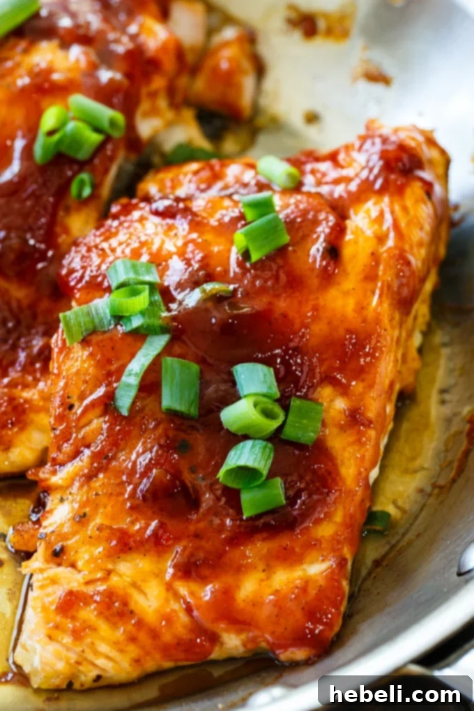 Flaked Honey BBQ Salmon on a fresh salad, perfect for leftovers.